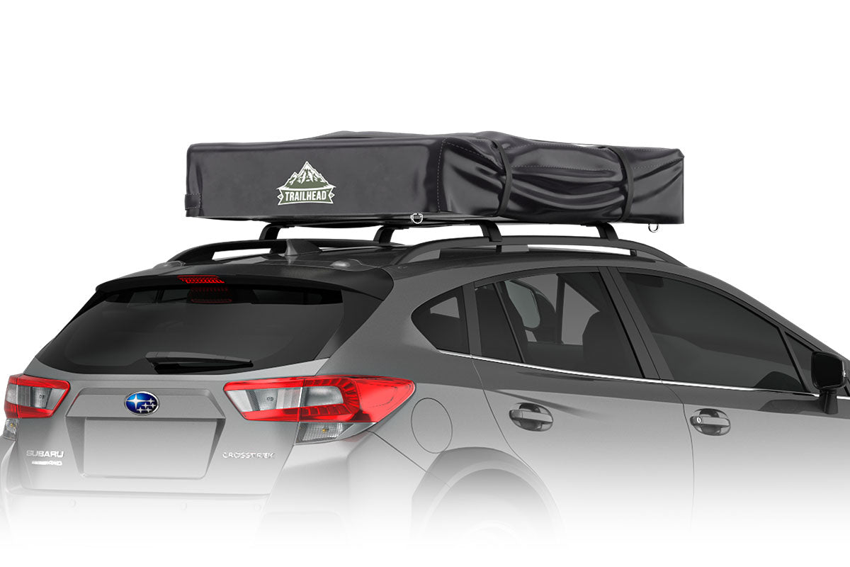 Trailhead tent setup on a vehicle in the wilderness